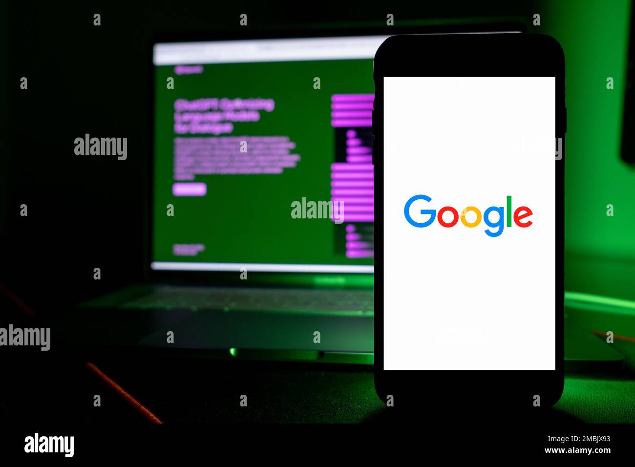 Azores, Portugal - 16.01.2023: SmartPhone Screen with Google Logo, and in the Background defocused the AI ChatGPT home page. Developed by OpenAI. Stock Photo
