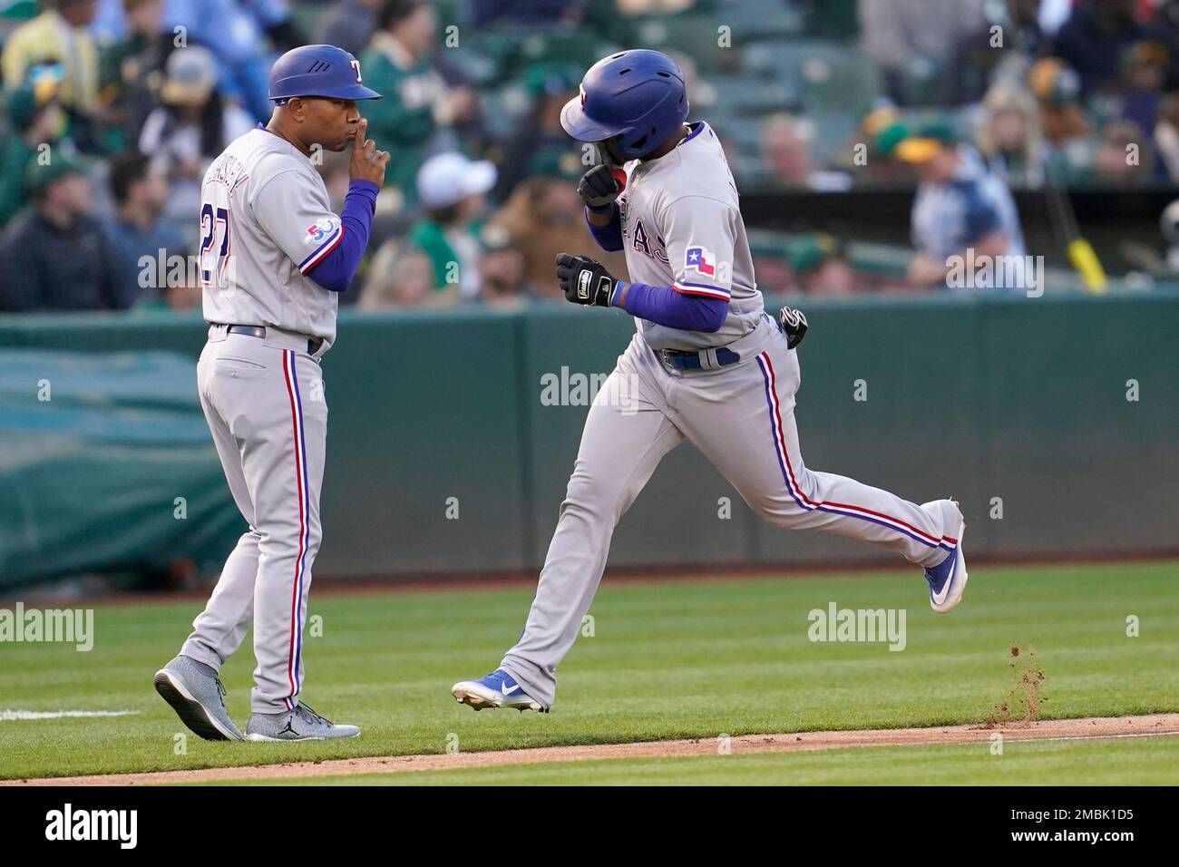 Texas Rangers' Andy Ibanez, right, is congratulated by third base coach  Tony Beasley after hitting a home run against the Oakland Athletics a  baseball game in Oakland, Calif., Friday, April 22, 2022. (