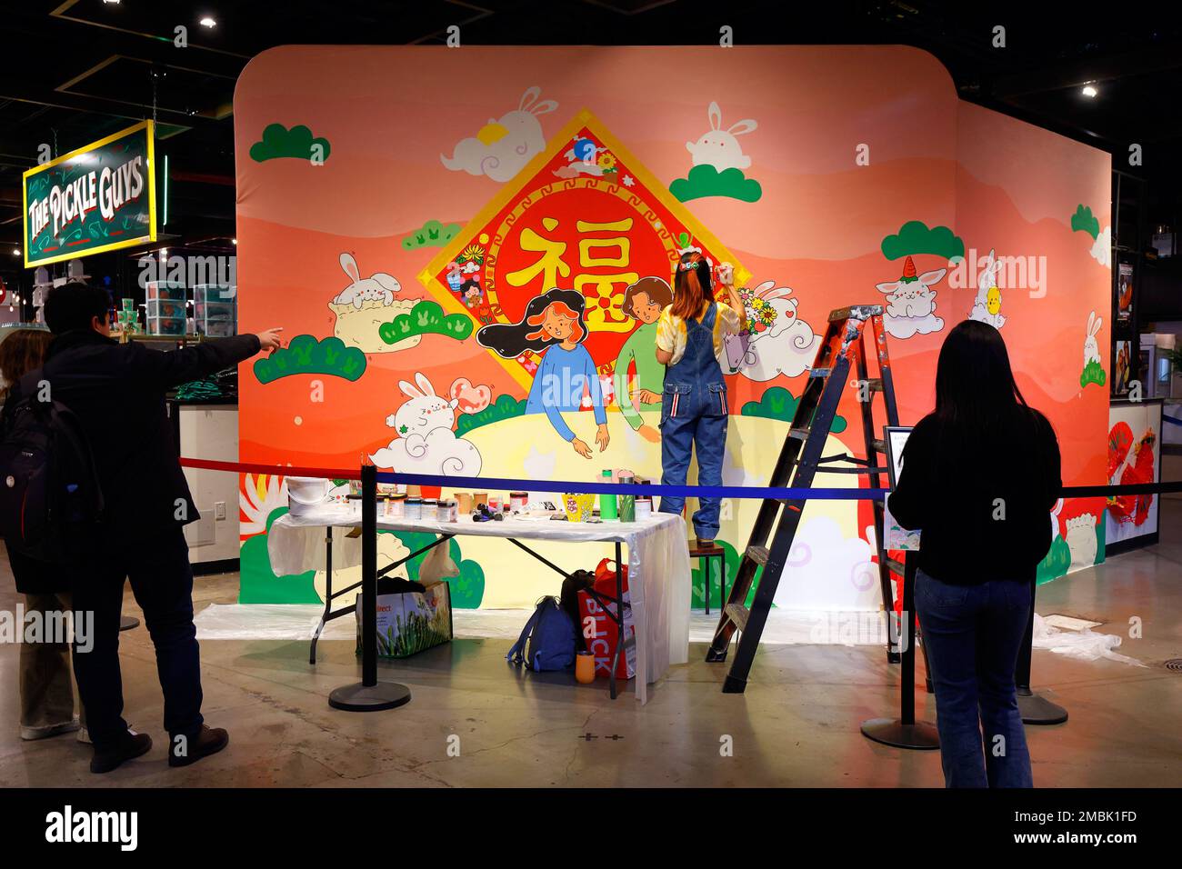 Artist Helen So works on a Lunar New Year painting at the Essex Market in New York City, January 20, 2023. The painting features ...(see more details) Stock Photo
