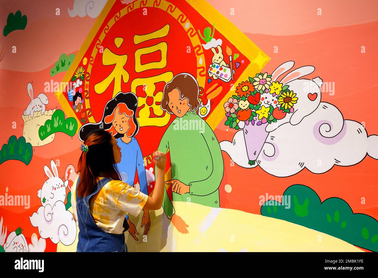 Artist Helen So works on a Lunar New Year painting at the Essex Market in New York City, January 20, 2023. The painting features ...(see more details) Stock Photo