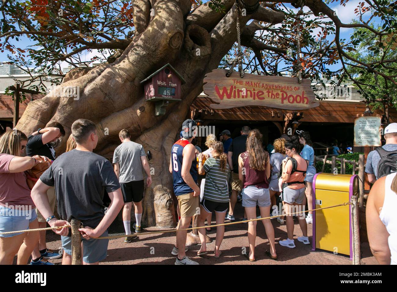 Pooh Ride Sign People wait in line for The Many Adventures of Winnie the Pooh ride at ...