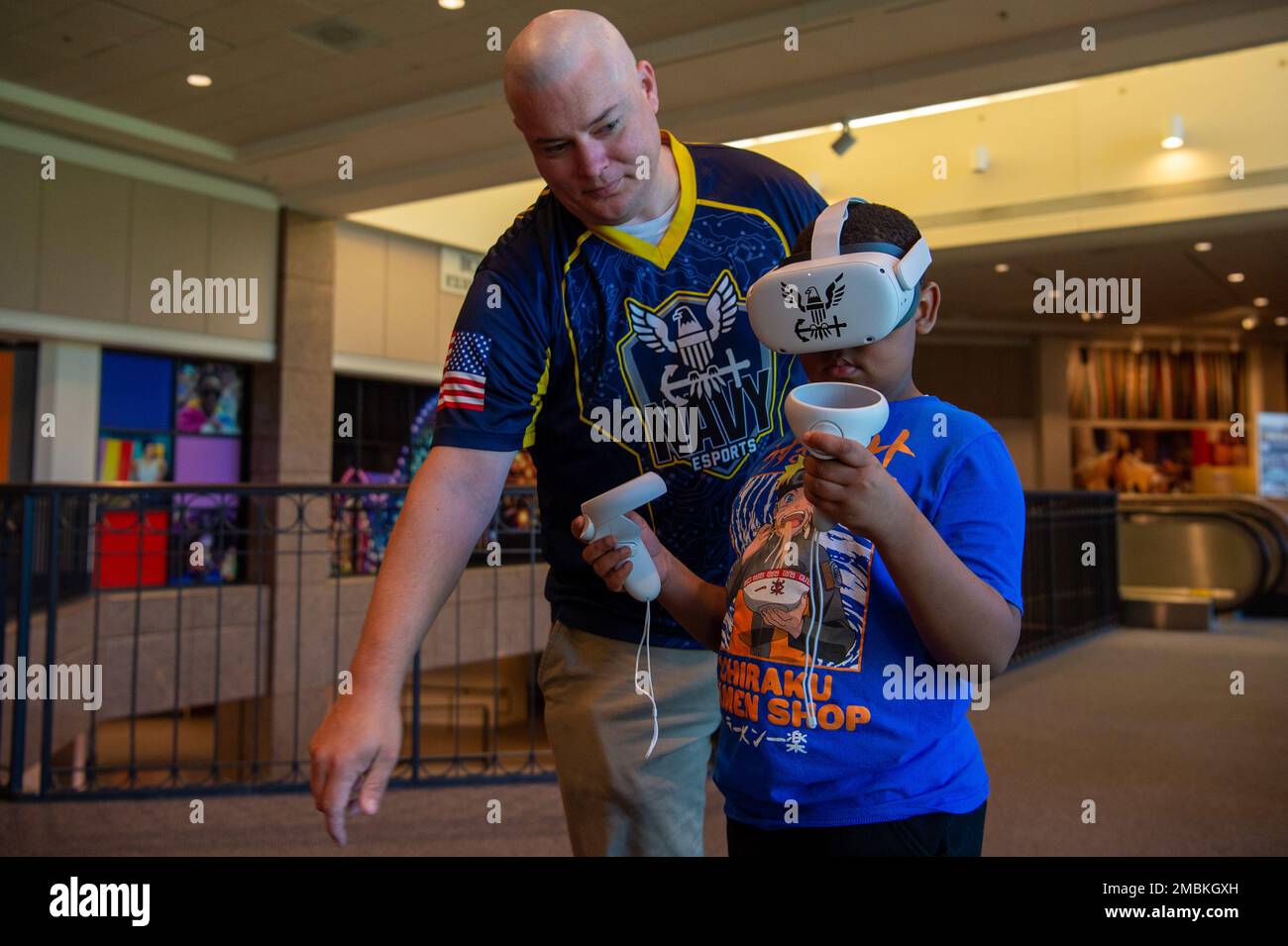 Memphis, Tenn. (June 16, 2022) Chief Electronics Technician (Navigation) Michael Cox, assigned to the Navy’s eSports team, shows a camper how to play a virtual reality game at The Museum of Science & History in Memphis during Navy Week Memphis. Memphis Navy Week is one of 14 Navy Weeks in 2022, which brings a variety of assets, equipment, and personnel to a single city for a weeklong series of engagements designed to bring America's Navy closer to the people it protects. Each year, the program reaches more than 140 million people -- about half the U.S. population. Stock Photo