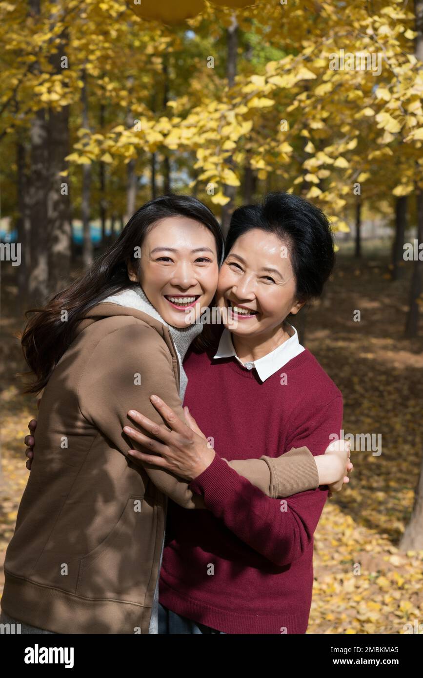 Mother and daughter two people walking here ginkgo Lin Stock Photo