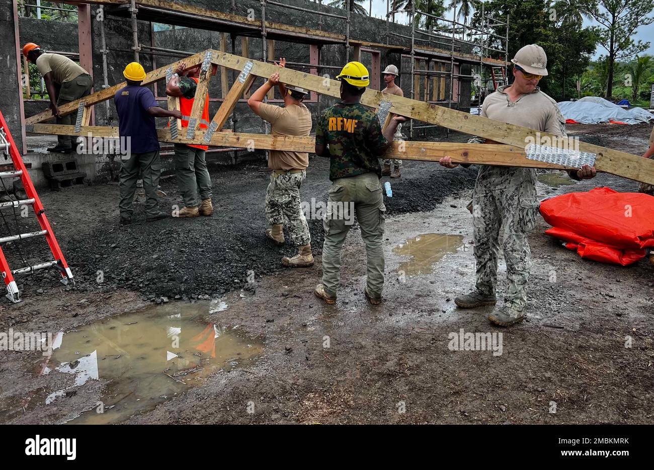 SAVUSAVU, Republic of Fiji (June 16, 2022) U.S. Navy Seabees assigned to Naval Mobile Construction Battalion 3 (NMCB-3), alongside members of the Republic of Fiji Military, position roof trusses in support of a Pacific Partnership 2022 engineering project in Savusavu, Fiji. Now in its 17th year, Pacific Partnership is the largest annual multinational humanitarian assistance and disaster relief preparedness mission conducted in the Indo-Pacific. Stock Photo