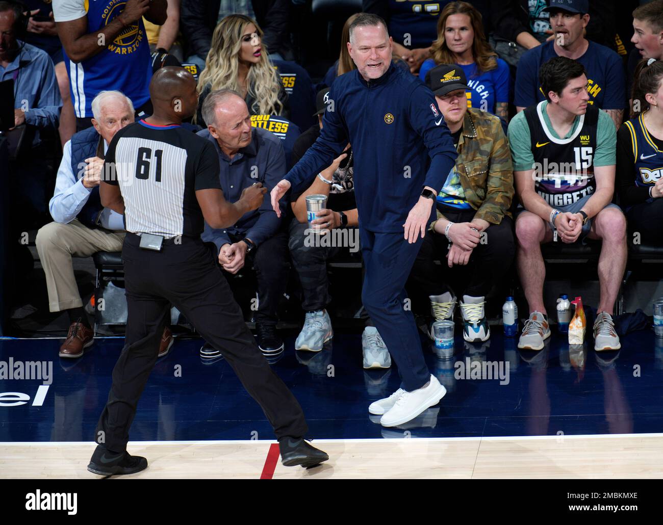 Denver Nuggets head coach Michael Malone, right, argues for a call with