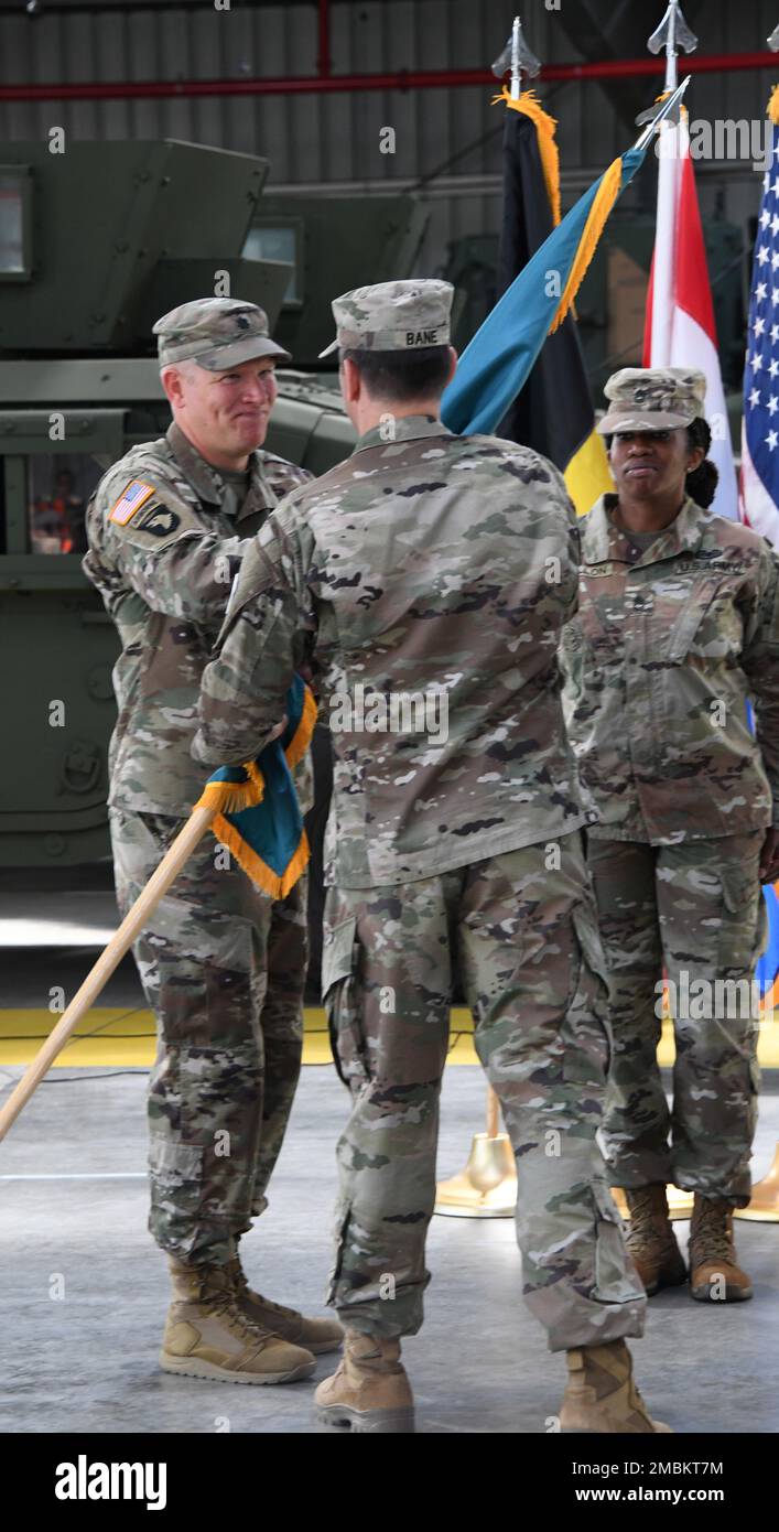 The 405th Army Field Support Brigade Commander, Col. Brad Bane, passes the Army Field Support Battalion-Benelux colors to Lt. Col. Blake Smith, signifying Smith’s official appointment as commander of AFSBn-Benelux. Smith assumed command of the battalion from Lt. Col. Aaron Jones during a ceremony at the Zutendaal Army Prepositioned Stocks-2 worksite in Belgium, June 16. (photo by Henri Cambier) Stock Photo