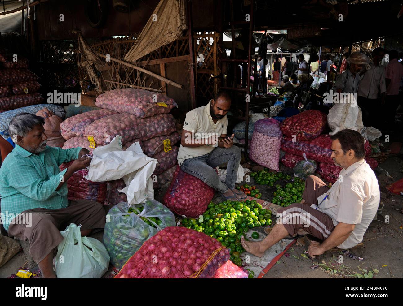 Vendors sell their vegetables at a wholesale market in Lucknow, capital of the northern Indian