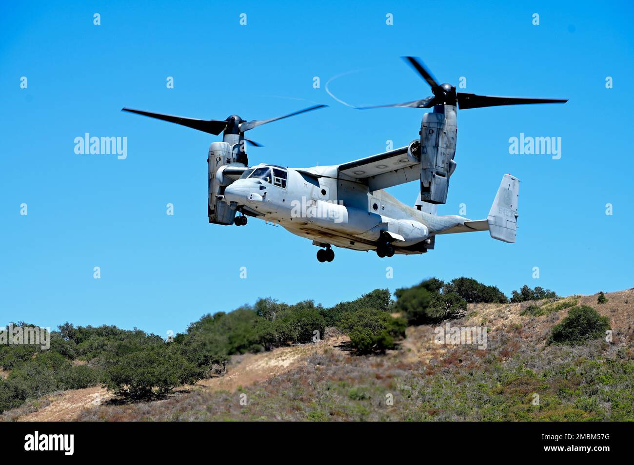 A U.S. Marine Corps MV-22 Osprey lands on a recently repaired runway during  Operation Turning Point on Vandenberg Space Force Base, Calif., June 16,  2022. The Osprey quickly touched down, loaded personnel, and took off in  order to test the runway for viability following repairs to it. Stock Photo