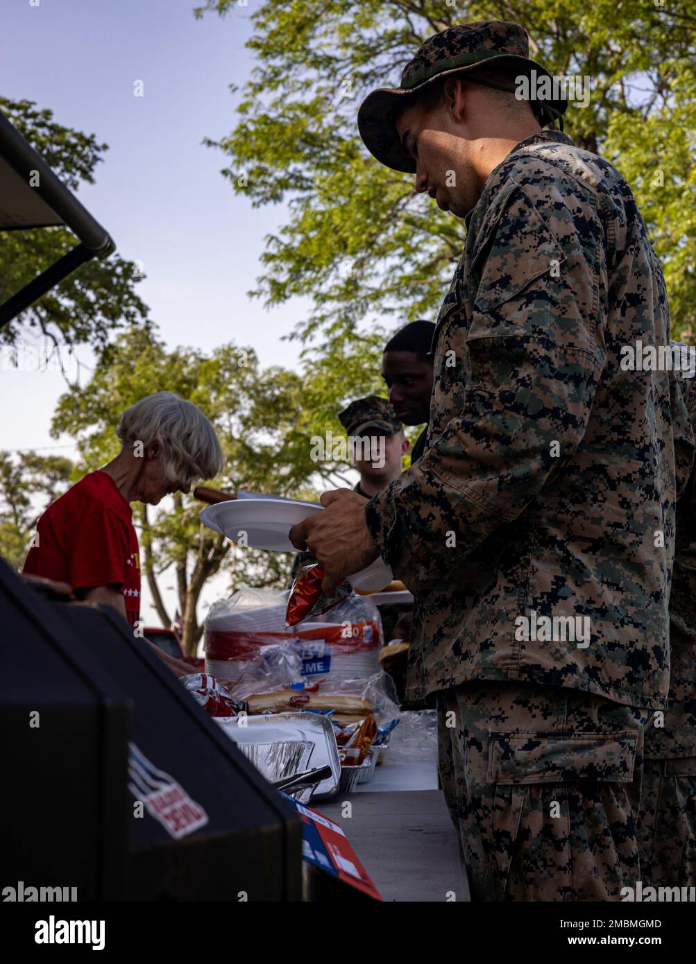U.S. Marines with Marine Light Attack Helicopter Squadron (HMLA) 773 Detachment A, 4th Marine Aircraft Wing, line up for food provided by Veterans of Foreign Wars (VFW) Post 1432 during exercise Gunslinger 22 at Salina, Kansas on June 17, 2022. The VFW traces its roots back to 1899 when veterans of the Spanish-American War (1898) and the Philippine Insurrection (1899-1902) founded local organizations to secure rights and benefits for their service. Stock Photo