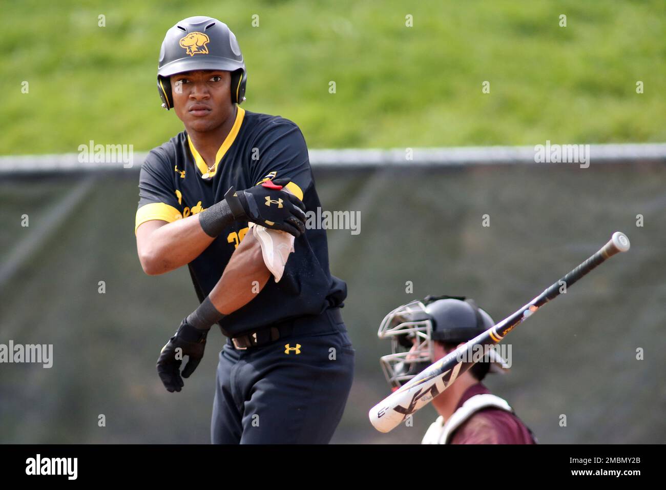 UMBC outfielder Justin Taylor (30) tosses his bat during an NCAA ...