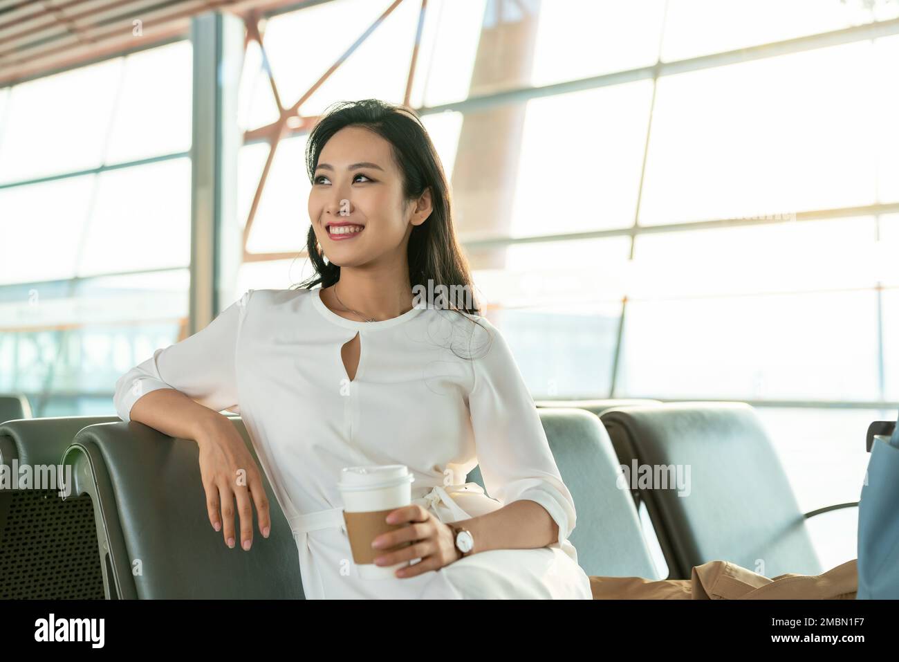 A young woman in the airport lounge waiting Stock Photo - Alamy