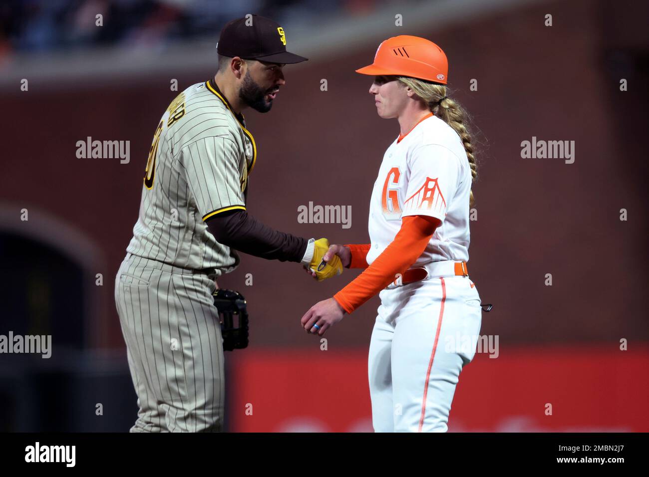San Diego Padres first baseman Eric Hosmer, left, shakes hands with San