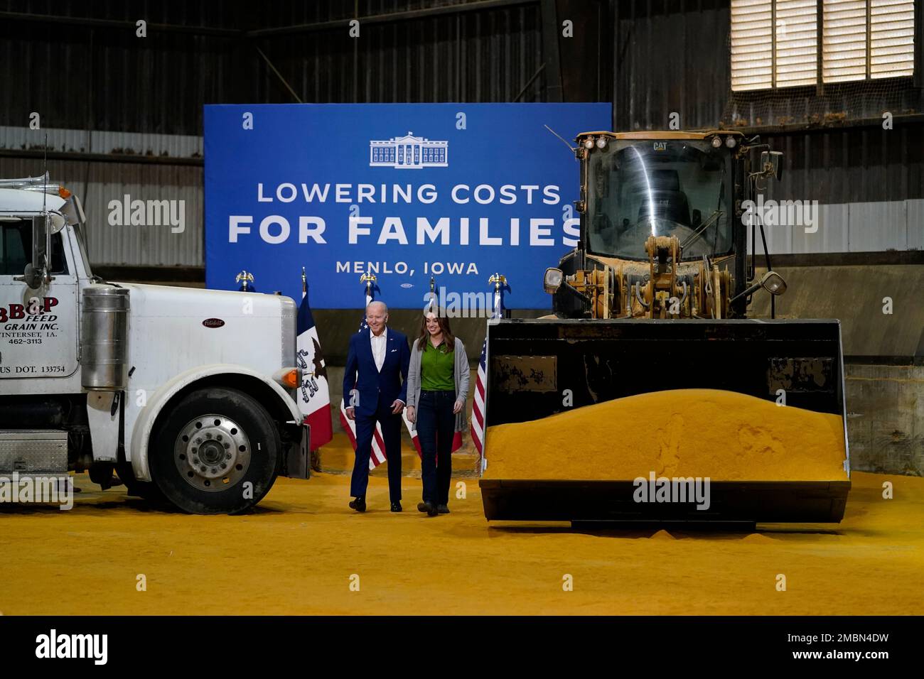 President Joe Biden walks with Rachel Connor, a grain merchandiser with