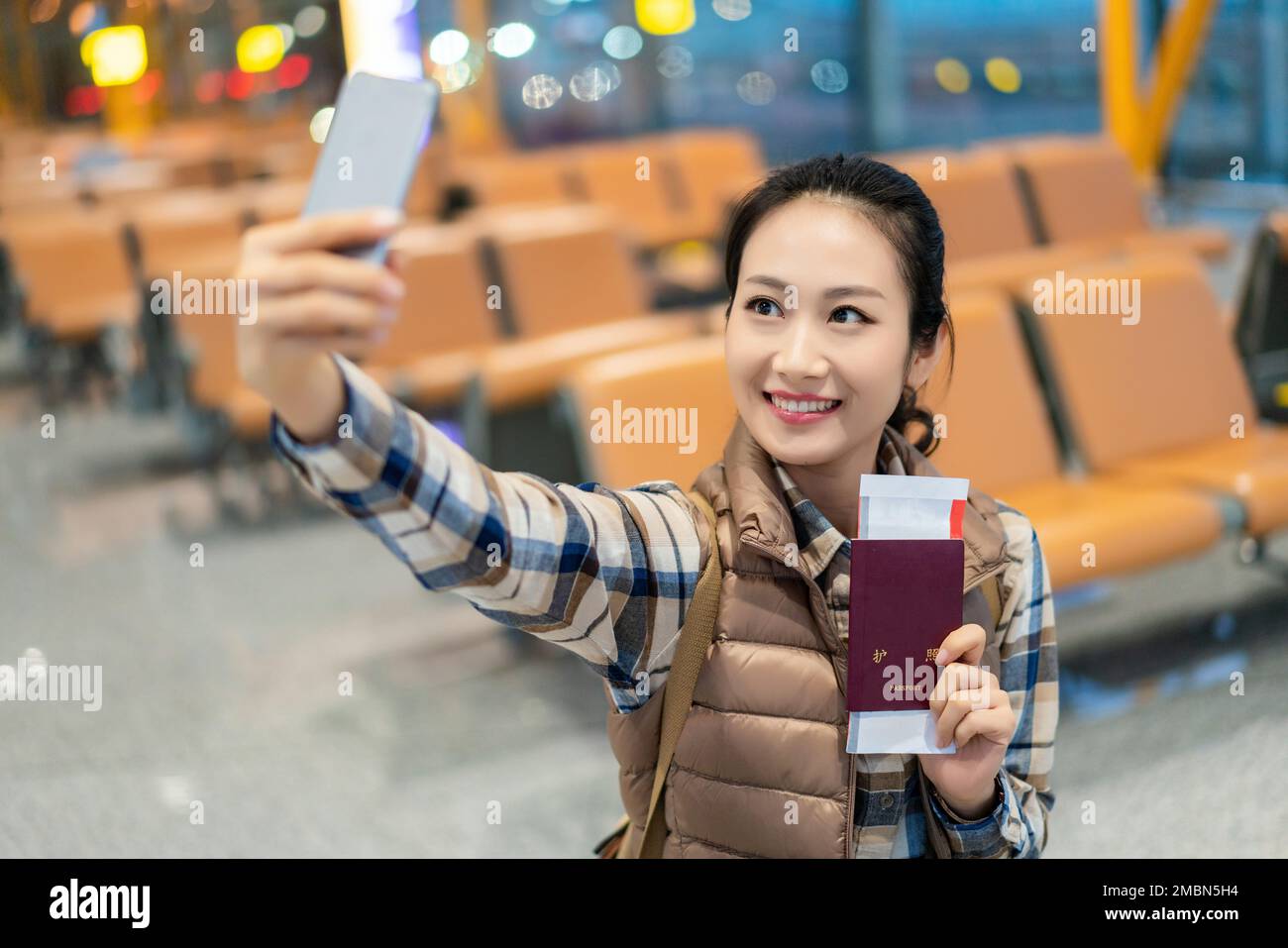 A young woman in the airport lounge Stock Photo - Alamy