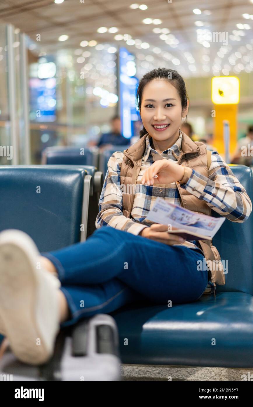 A young woman in the airport lounge Stock Photo - Alamy