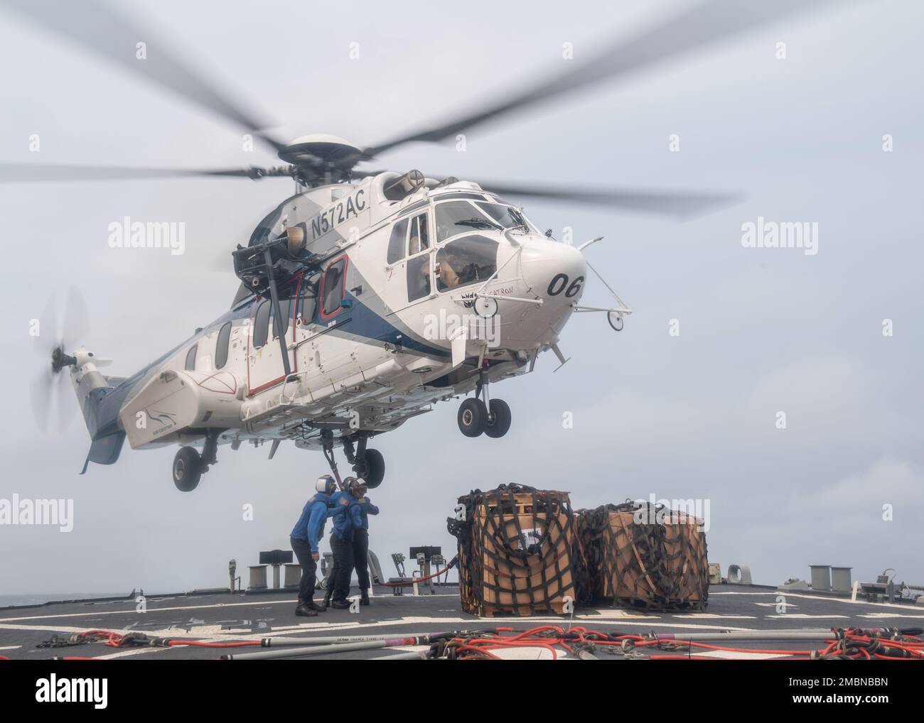 220617-N-VF045-1165   NORTH PACIFIC OCEAN (June 17, 2022) Sailors hook up cargo to a H215 Super Puma helicopter attached to the Lewis and Clark-class dry cargo and ammunition ship USNS Cesar Chavez (T-AKE 14) on the flight deck aboard Arleigh Burke-class guided-missile destroyer USS Milius (DDG 69). Milius is assigned to Task Force 71/Destroyer Squadron (DESRON) 15, the Navy’s largest forward-deployed DESRON and the U.S. 7th fleet’s principal surface force. Stock Photo