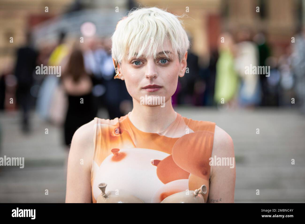 Emma Corrin poses for photographers upon arrival at the Olivier Awards