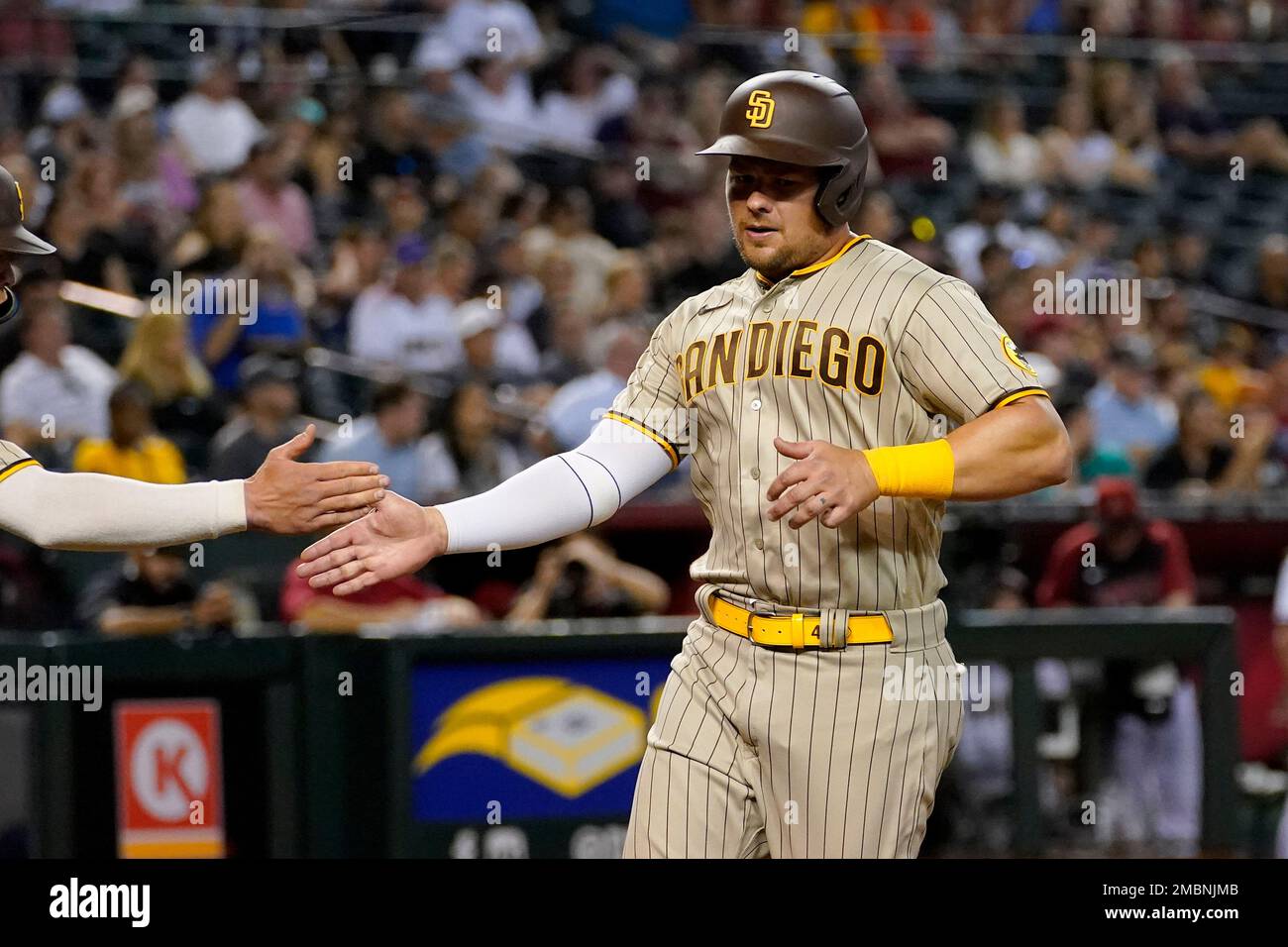 San Diego Padres' Luke Voit scores on a sacrifice fly by Austin Nola during  the eighth inning of a baseball game against the Arizona Diamondbacks,  Saturday, April 9, 2022, in Phoenix. (AP