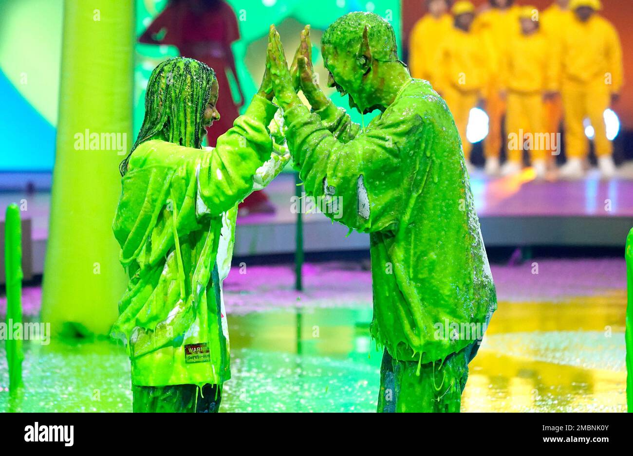 Kid Cudi, right, and his daughter Vada Wamwene Mescudi high-five after