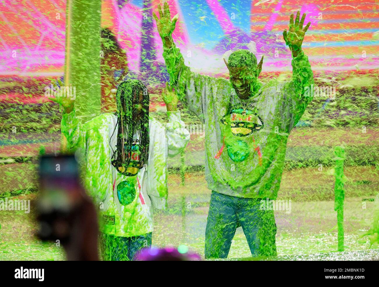 Kid Cudi, right, and his daughter Vada Wamwene Mescudi get slimed at