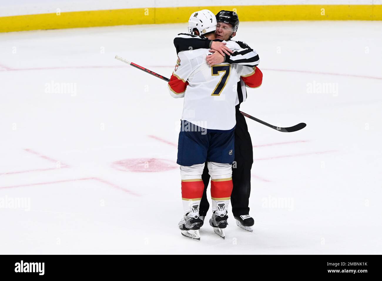 Linesman Vaughan Rody (73) hugs Florida Panthers right wing Claude Giroux  (28) after Panthers defeated the