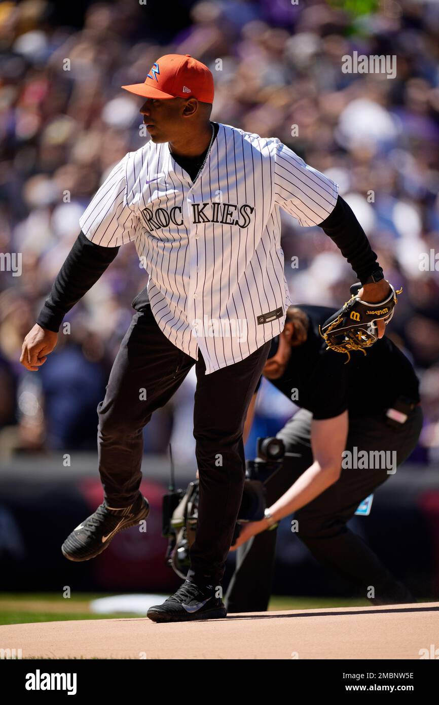 Denver Broncos quarterback Russell Wilson tosses out the first pitch during  ceremonies to mark the regular-season home opener as the Colorado Rockies  host the Los Angeles Dodgers in a baseball game Friday