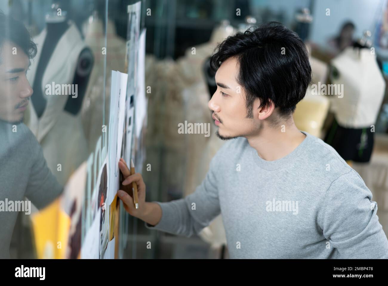 Fashion model fashion standing holding designer clothing hi-res stock ...