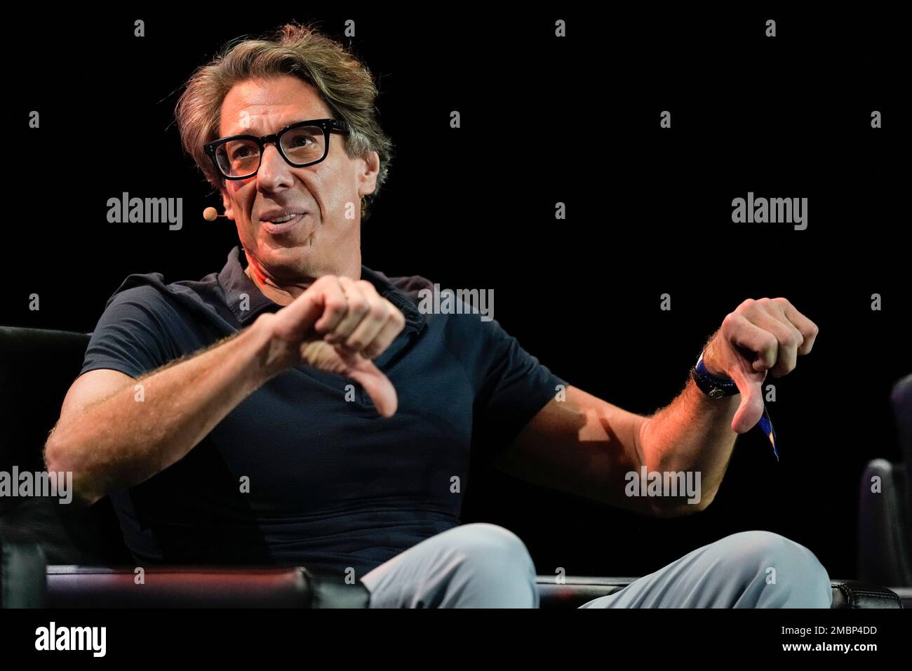 Dan Tapiero gives a thumbs down sign as he talks about bonds as an  investment, during a panel of billionaire investors at the Bitcoin  Conference, Thursday, April 7, 2022, in Miami Beach,