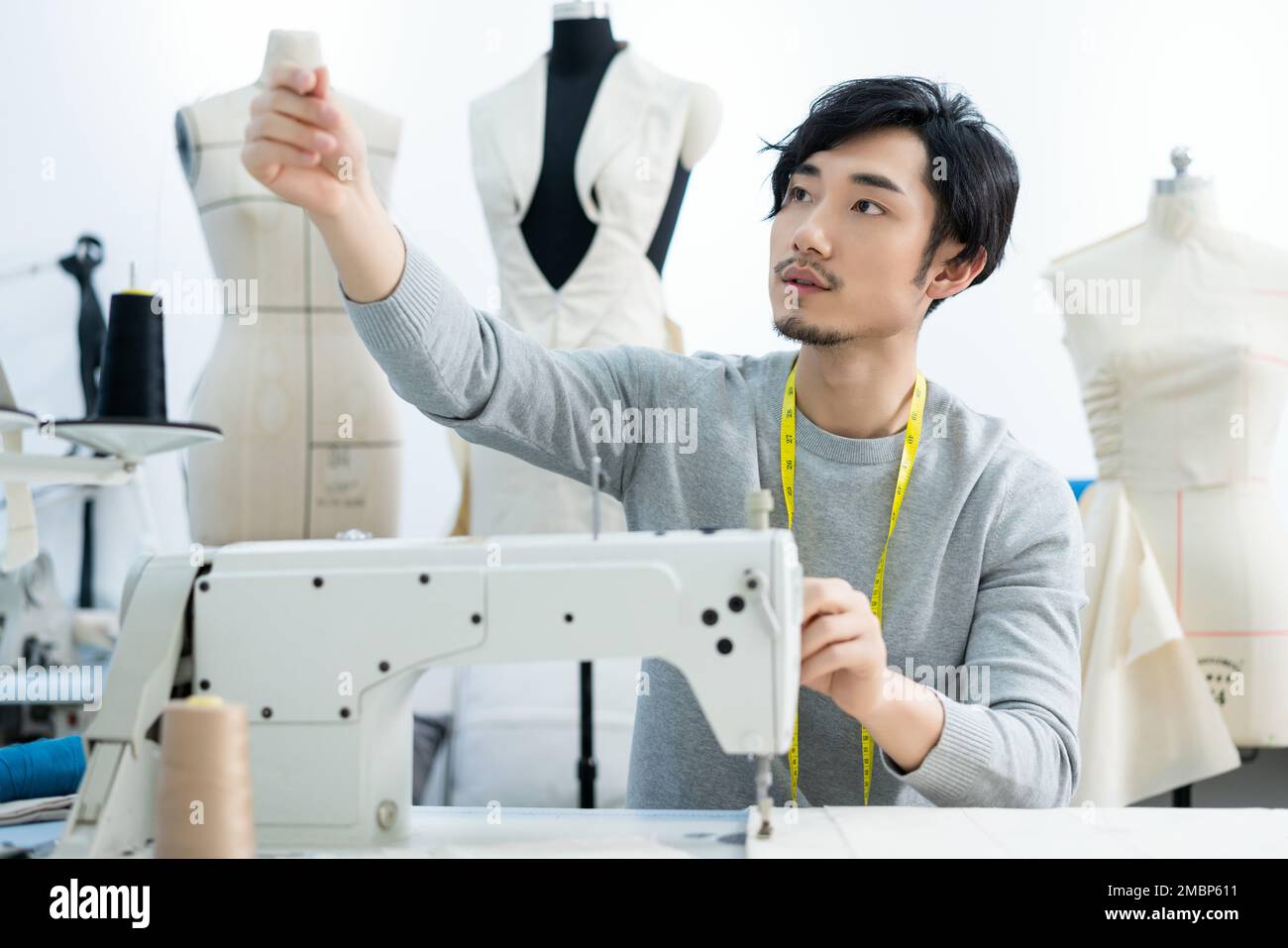 Asian male designer sewing machine hi-res stock photography and images ...