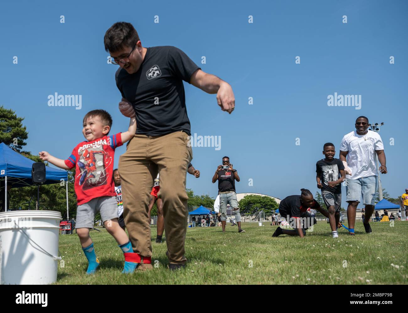 A member of Team Misawa and his son cross the finish line during the Juneteenth Family Reunion event at Misawa Air Base, Japan, June 18, 2022. The inaugural event hosted games and events celebrating Juneteenth as well as Father’s Day. Stock Photo