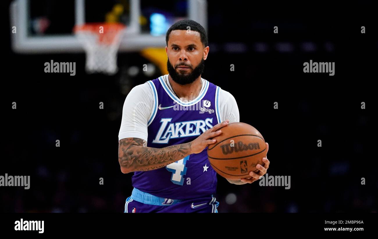 Los Angeles Lakers guard D.J. Augustin (4) controls the ball during the  first half of an NBA basketball game against the Golden State Warriors in  Los Angeles, Saturday, March 5, 2022. (AP
