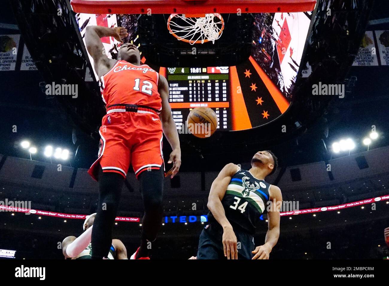 Chicago Bulls guard Ayo Dosunmu (12) dunks next to Milwaukee Bucks