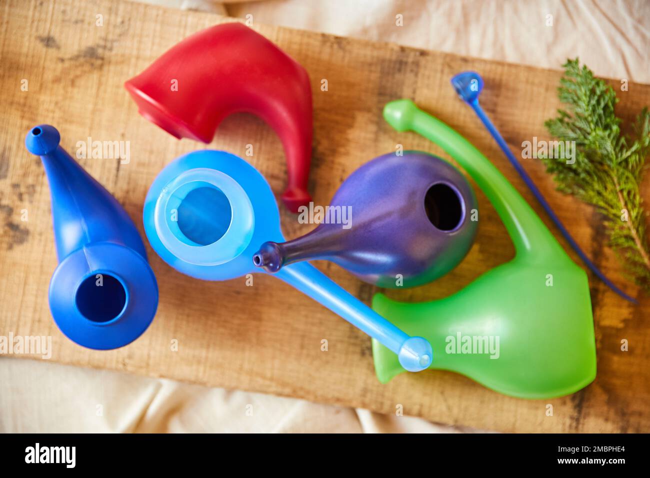 The best memories are made around the table. Overhead shot of colourful gravy boats on a wooden board. Stock Photo