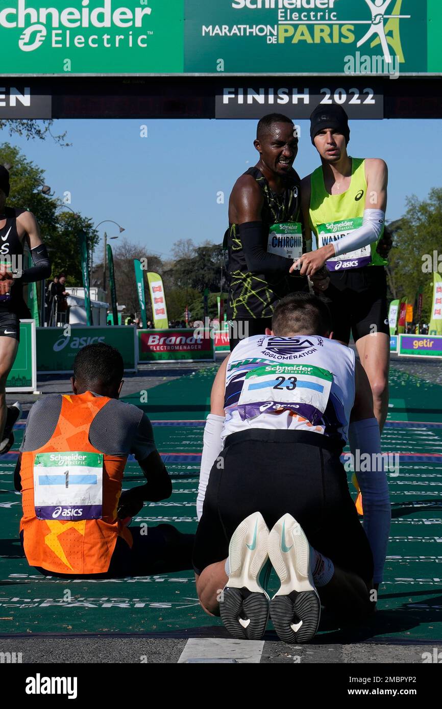 French-Swiss athlete Julien Wanders, standing right, holds the hand of  Kenya's Denis Chirchir after finishing the Paris Marathon, Sunday, April 3,  2022 in Paris. (AP Photo/Francois Mori Stock Photo - Alamy