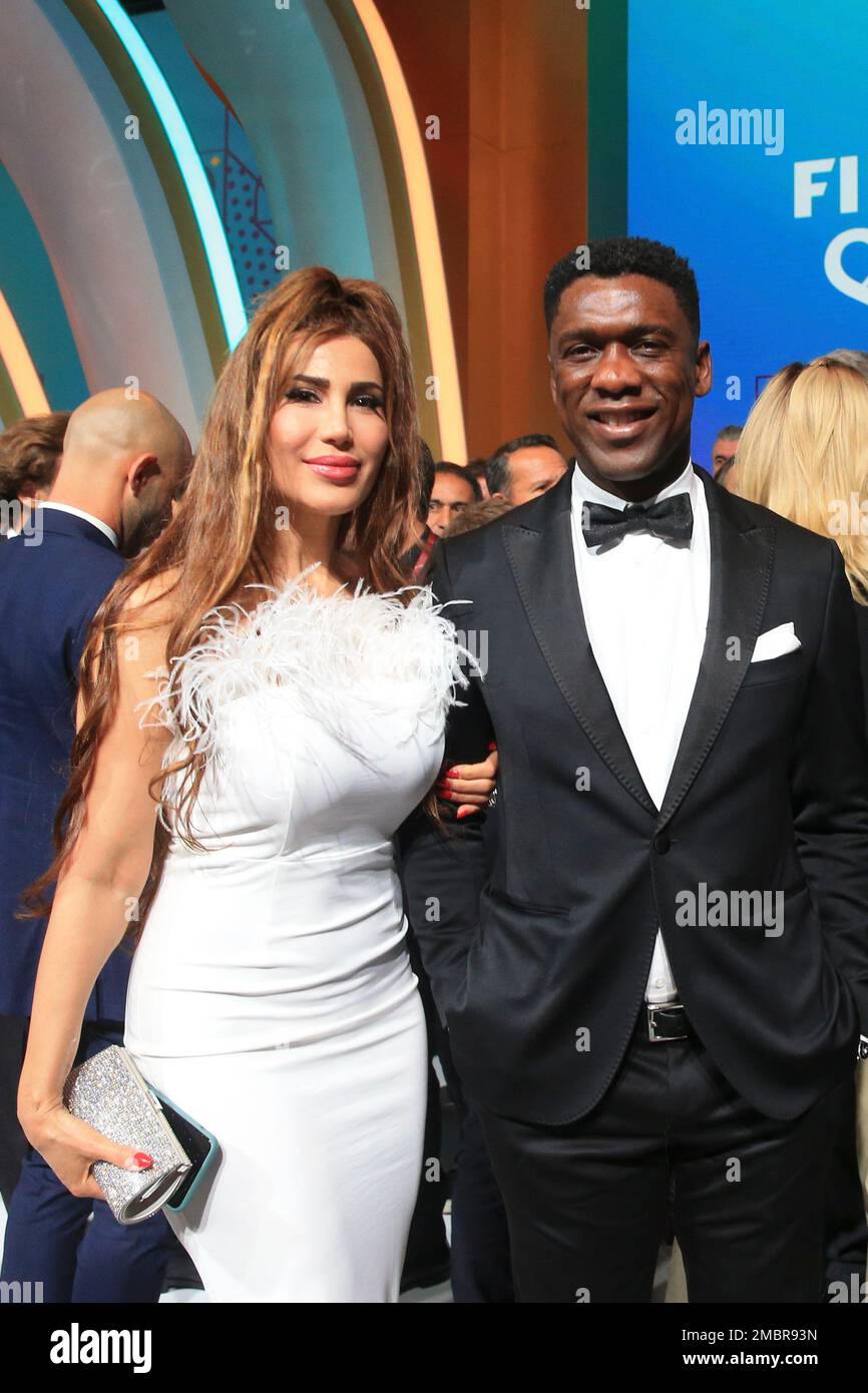 Clarence Seedorf and his wife Sophia Makramati pose following the 2022 soccer World Cup draw at