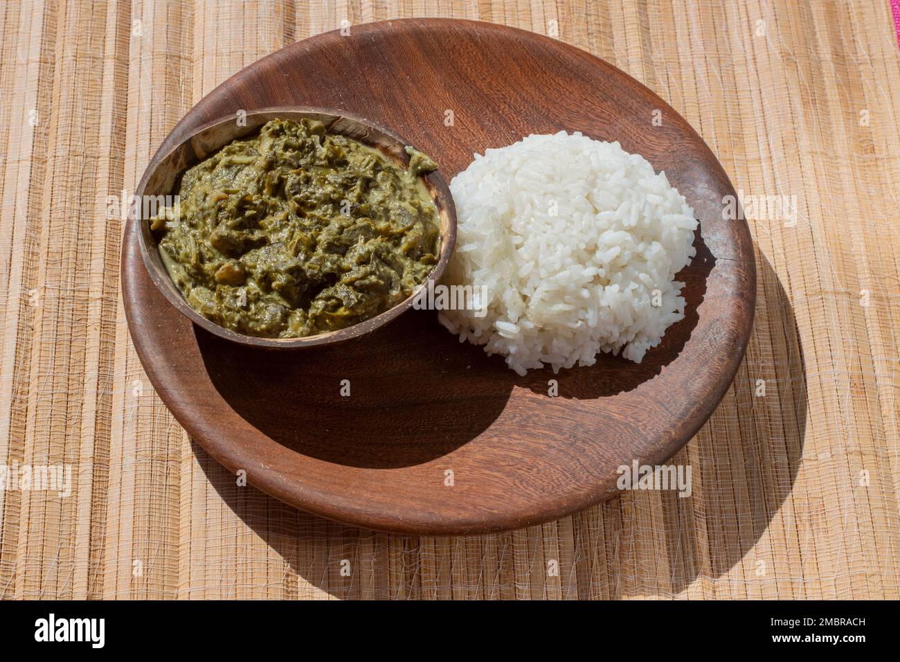 Cowpea leaves stew, a traditional African delicacy made with cow pea leaves, coconut milk, and peanut flour, served over a bed of fluffy white rice Stock Photo