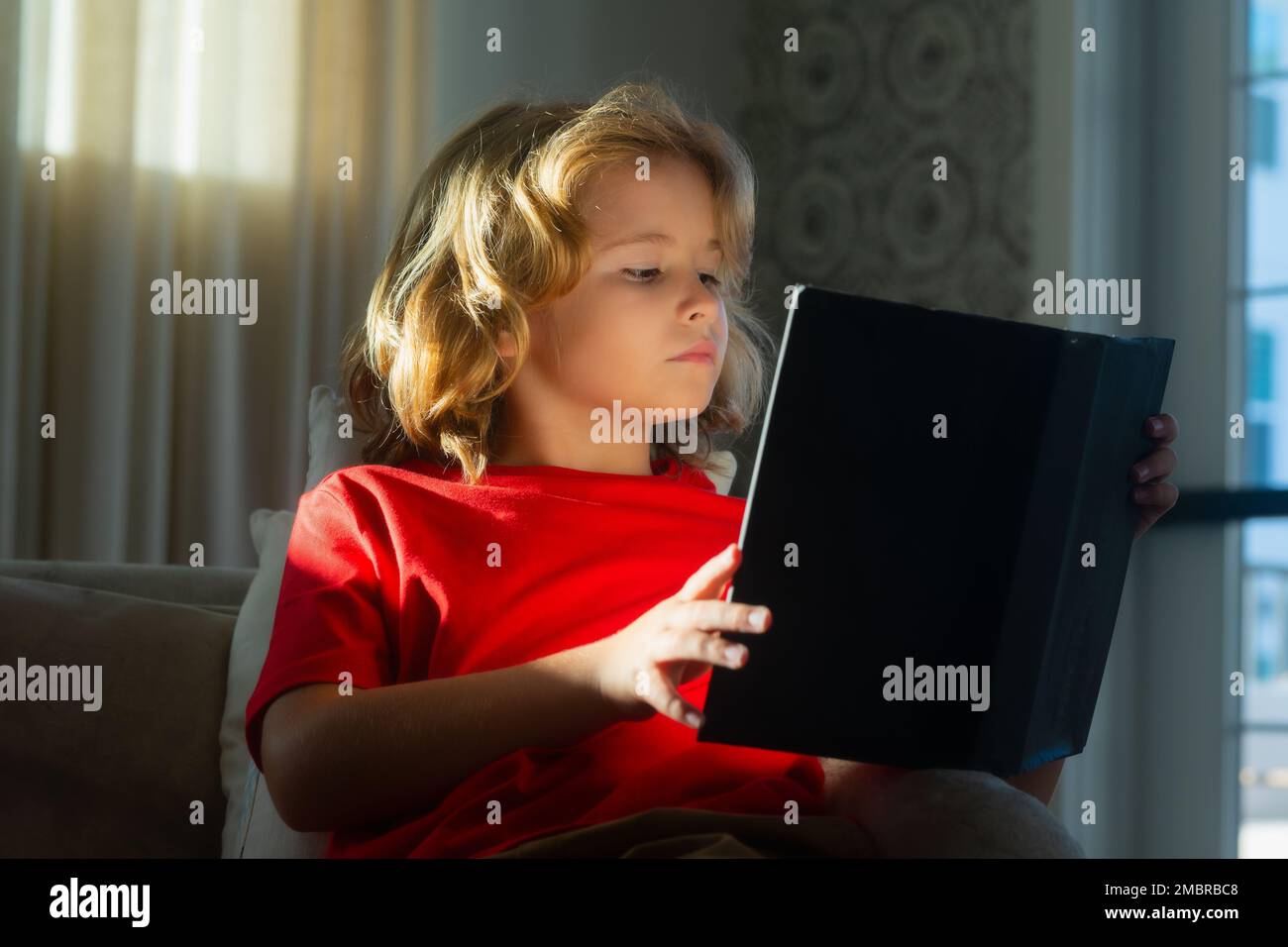 Smart, clever child. Intelligent kid boy read book. Little child boy