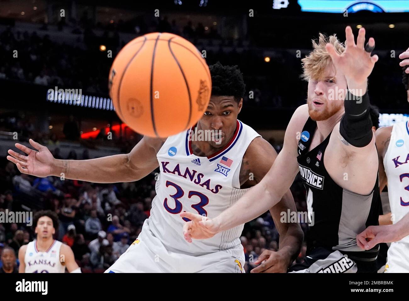 Kansas' David McCormack and Providence's Jared Bynum go after a loose