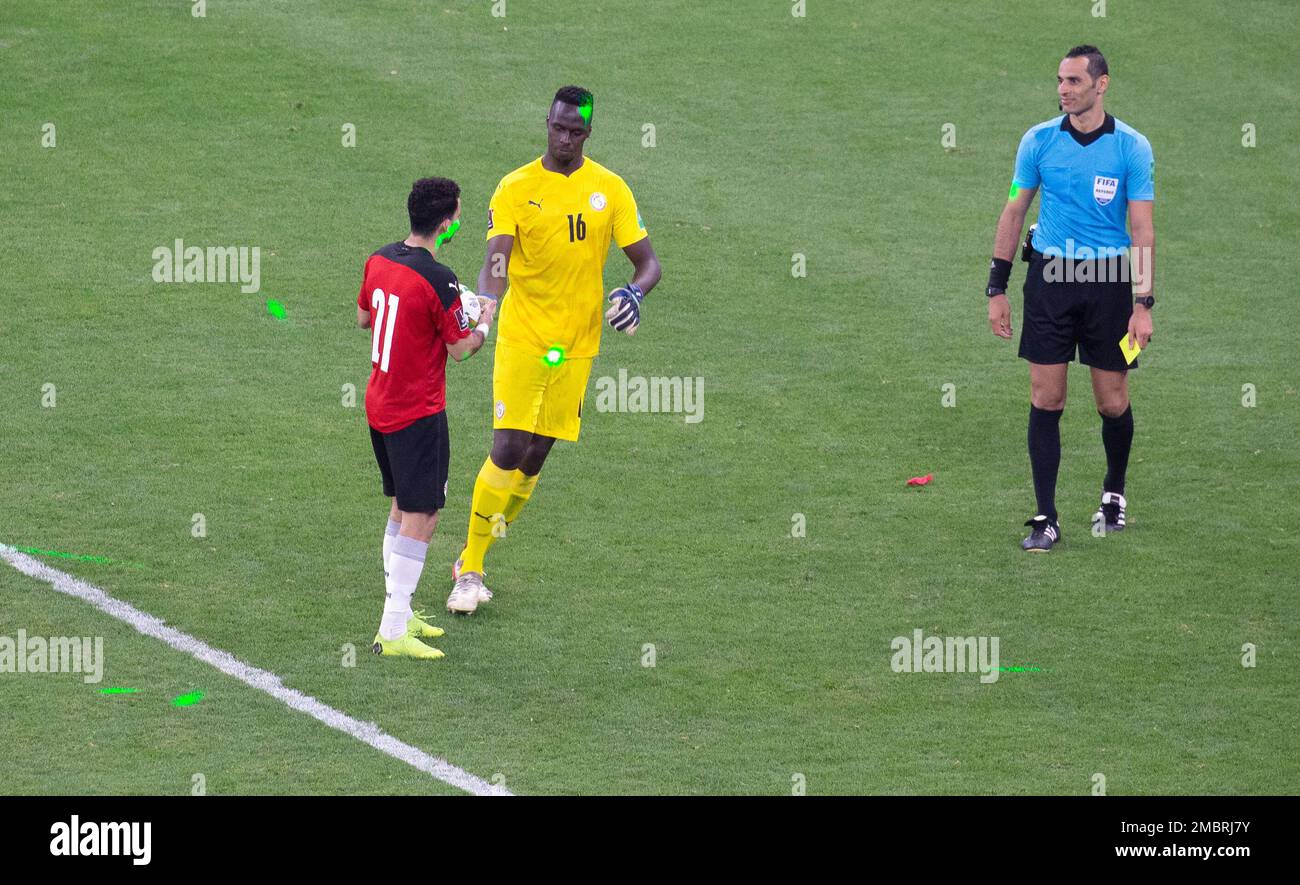 The light from green laser pointers can be seen on the pitch as Egypt's