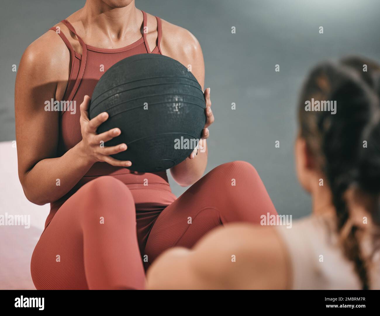 Fitness, team work or women training with medicine ball in workout or exercise with resilience at gym. Motivation, focused girls or healthy female Stock Photo