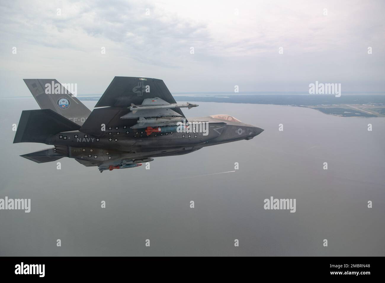 U.S. Marine Corps test pilot Maj. Dylan “Bilbo” Nicholas pilots an F-35C during a GBU-38/54 flight test at NAS Patuxent River, Maryland, on June 21, 2022. Before new weapons and aircraft capabilities are integrated into operational fleet squadrons the Pax River F-35 Integrated Test Force and Air Test and Evaluation Squadron (VX) 23 developmental test pilots thoroughly test them. The F-35, which has been operational since 2015, is the most lethal, survivable, and interoperable fighter aircraft ever built. Stock Photo