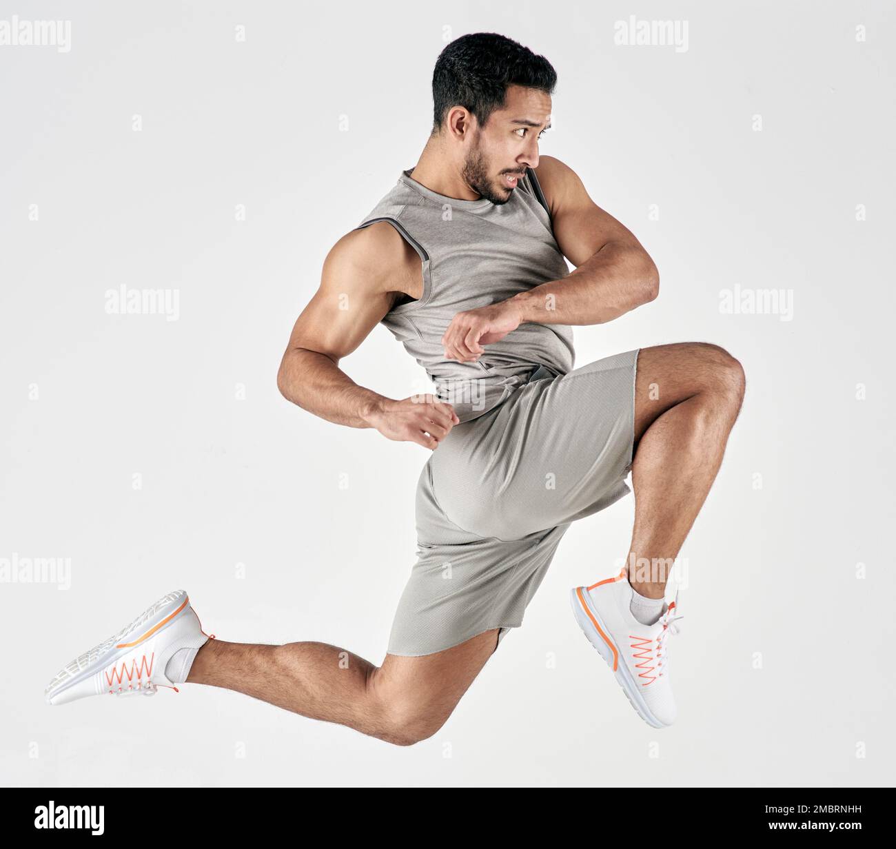 Turn pain into power, and power into growth. Studio shot of a muscular young man jumping against a white background. Stock Photo