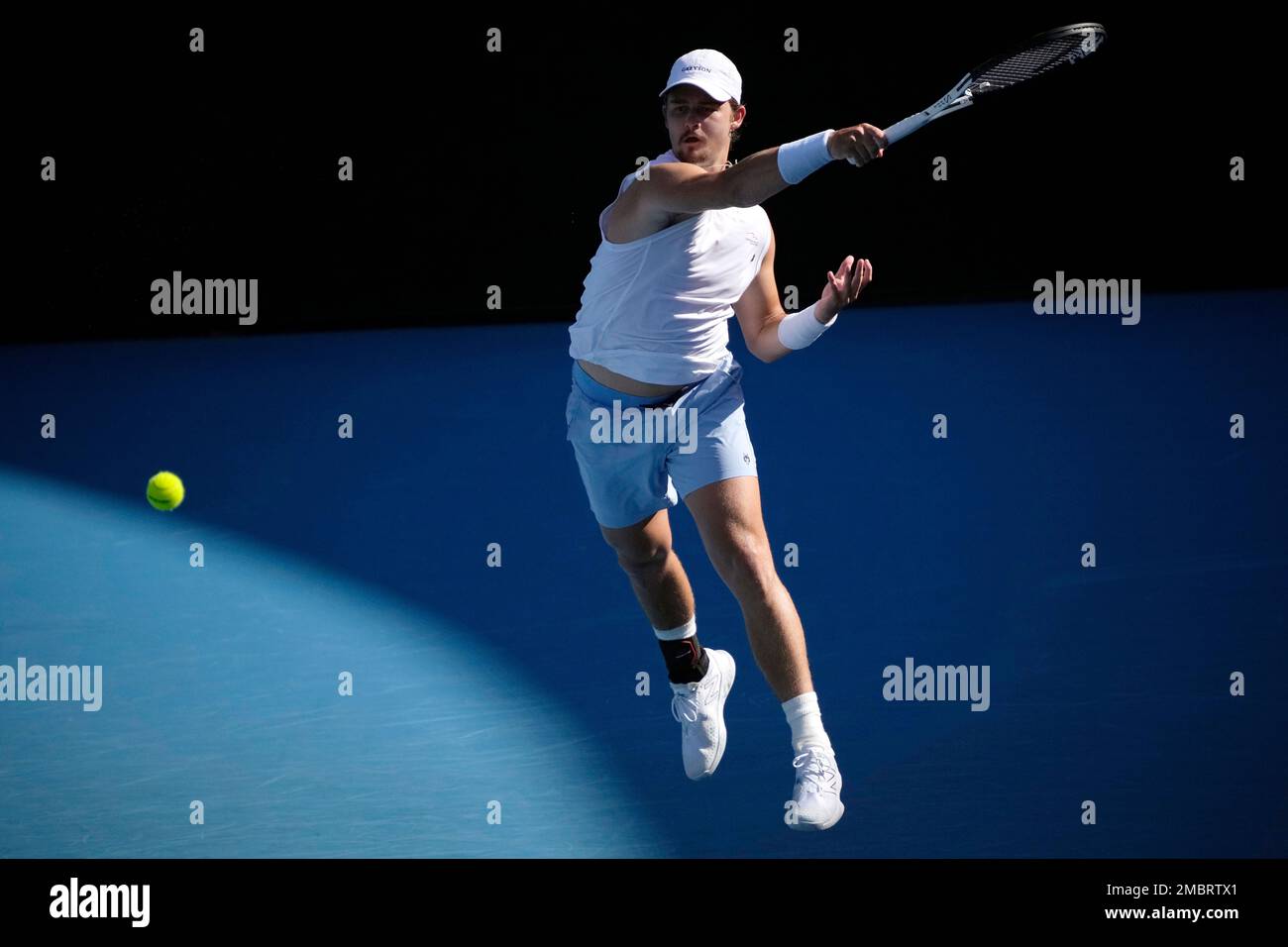 J.J. Wolf of the U.S. plays a forehand return to compatriot Michael Mmoh  during their third round match at the Australian Open tennis championship  in Melbourne, Australia, Saturday, Jan. 21, 2023. (AP