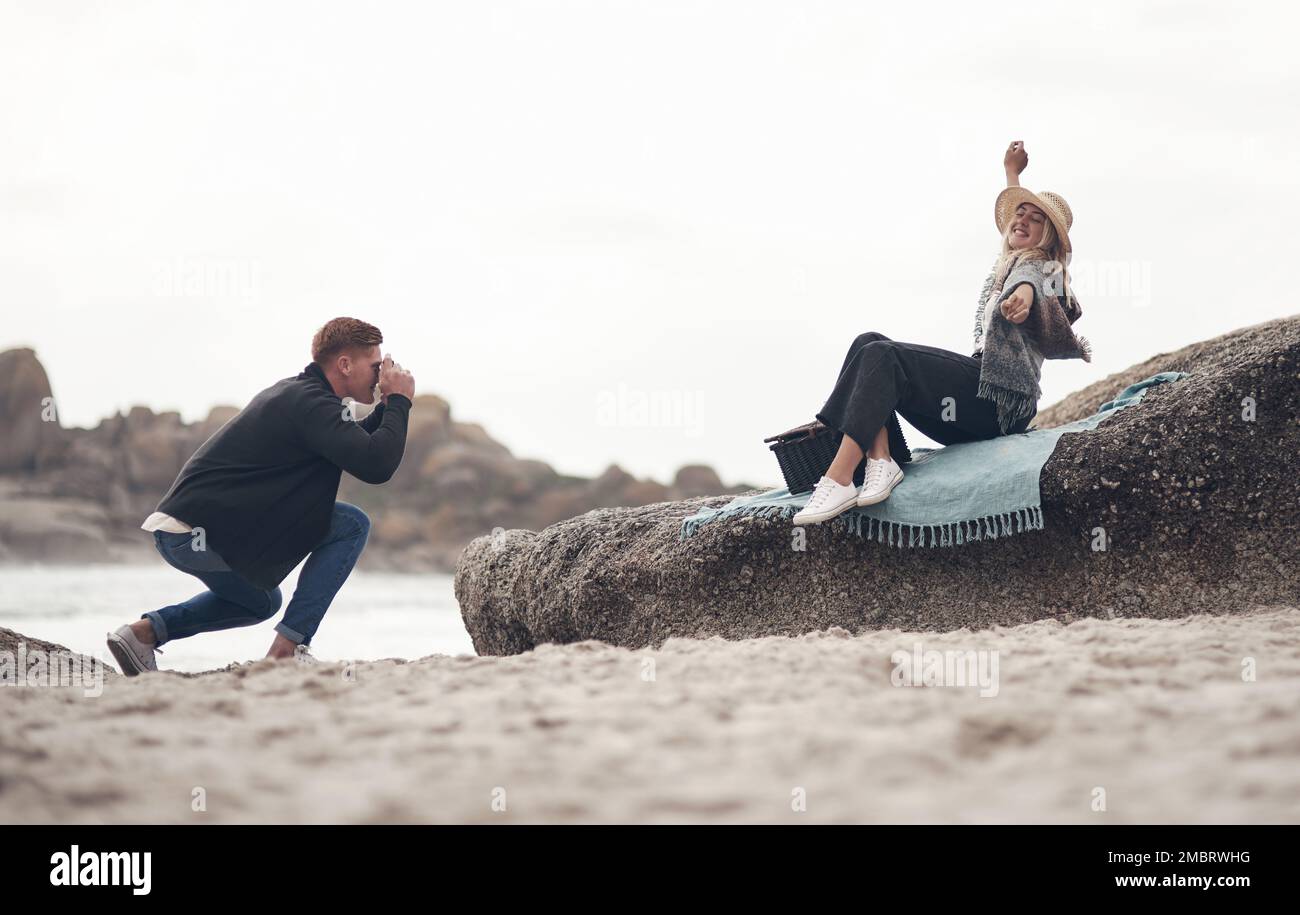 Im framing this one. a man taking pictures of his girlfriend while