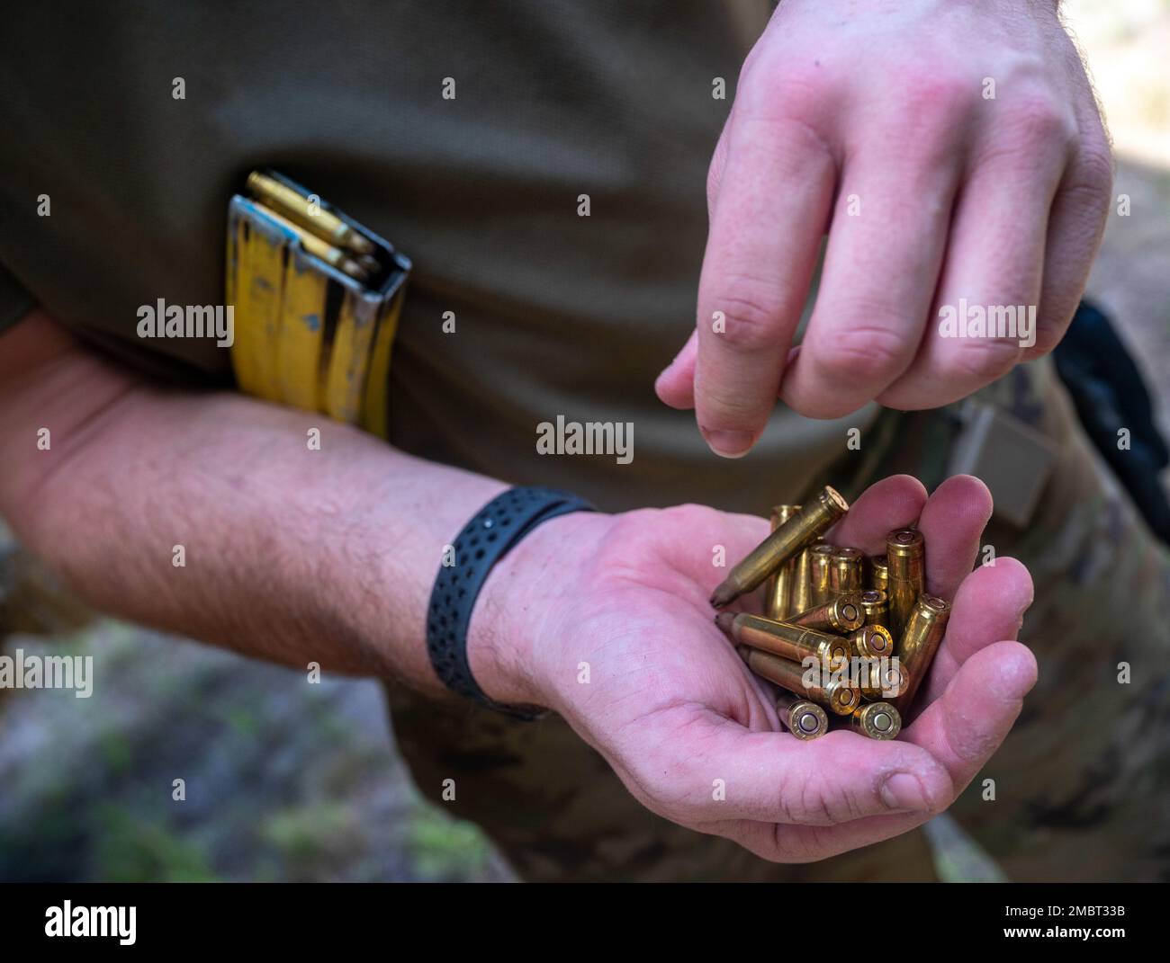 A U.S. Air Force Airman attending Fieldcraft Hostile (FCH) loads blank rounds into his magazine prior to a tactical exercise at Joint Base McGuire-Dix-Lakehurst on Aug. 2, 2022. FCH is a pre-deployment course directed by the 421st Combat Training Squadron, that teaches basic combat skills to over 5,000 U.S. Air Force, Joint and NATO personnel annually. Stock Photo