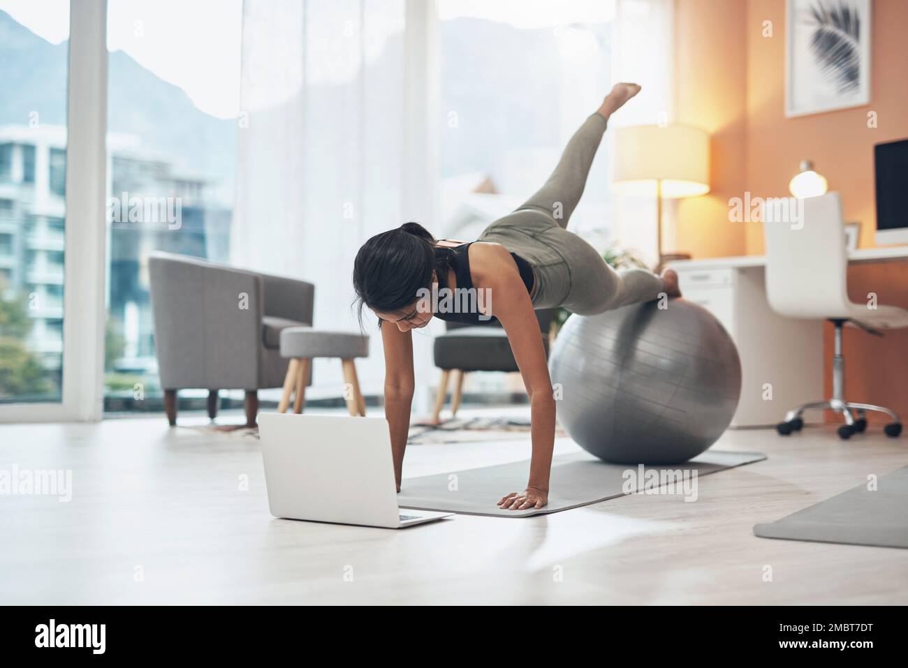 The internet helped me to up my fitness level. a woman working out in ...