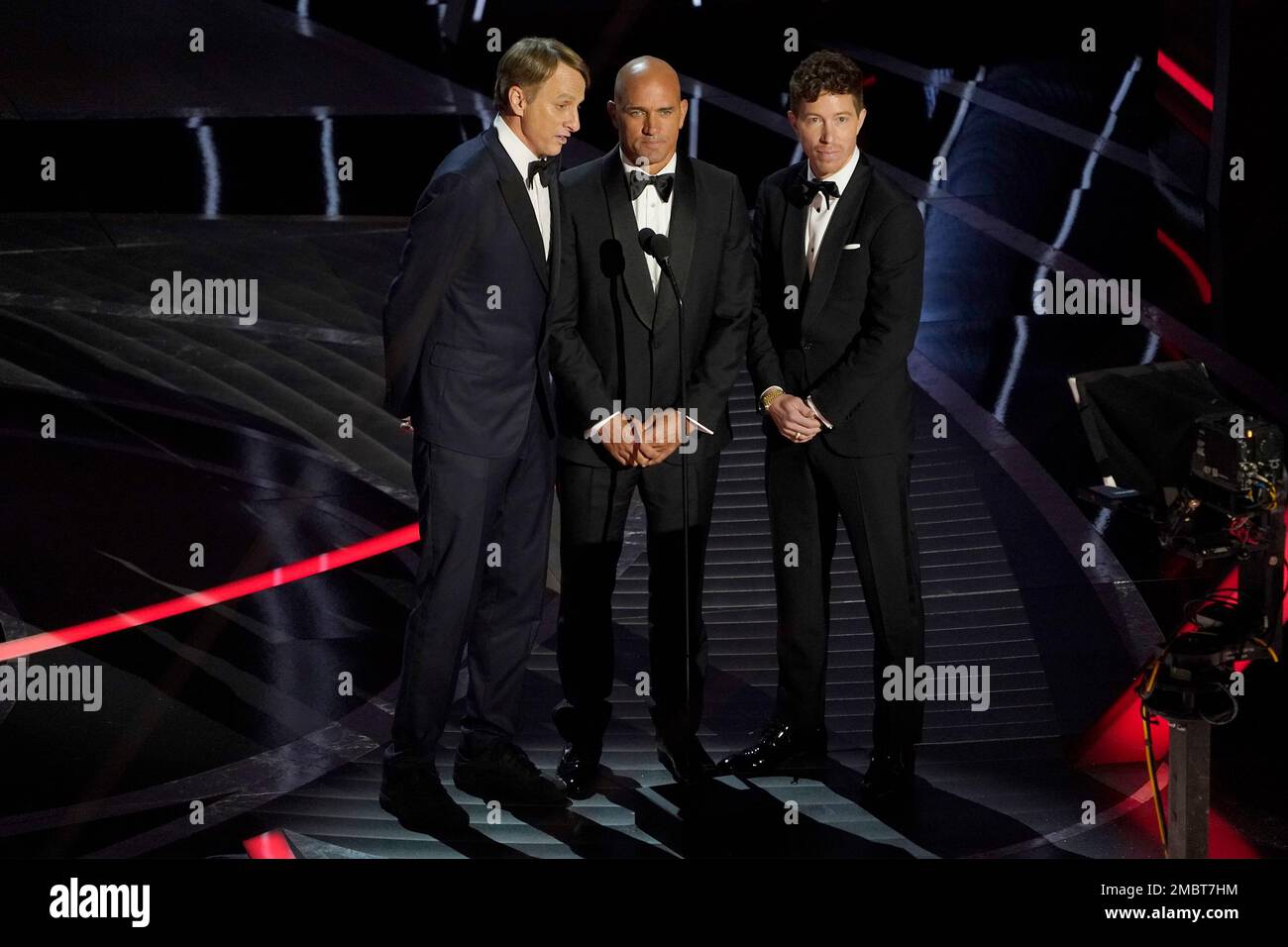 Tony Hawk, from left, Kelly Slater and Shaun White present a Bond