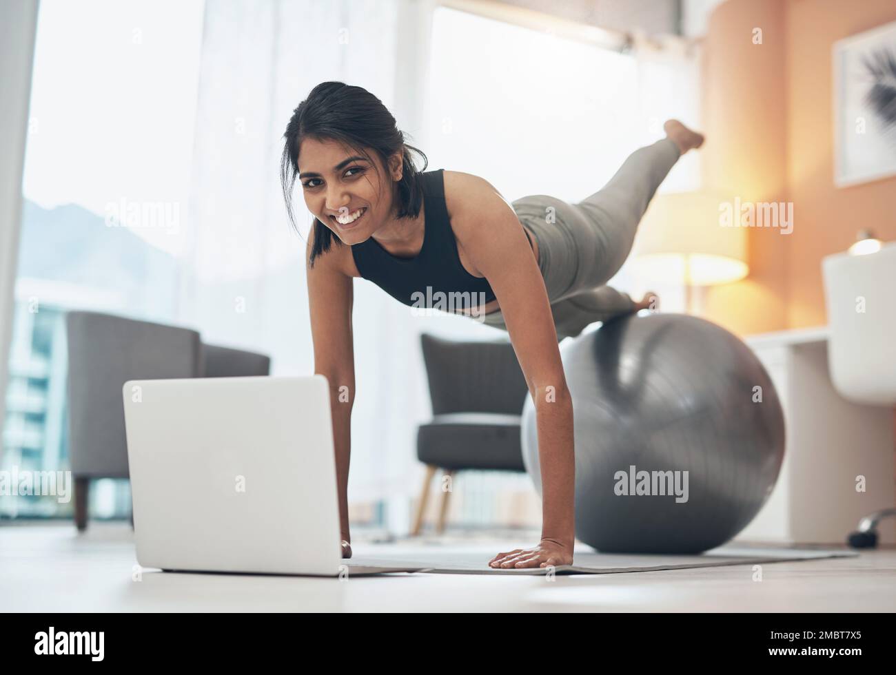 Person Working Out While Using Computer The gym might be close but the internet is always available. a woman ...