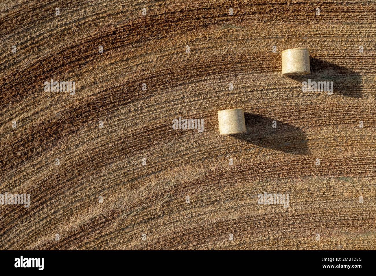 Drone aerial of hay bales in agriculture field after harvesting. Cyprus europe Stock Photo