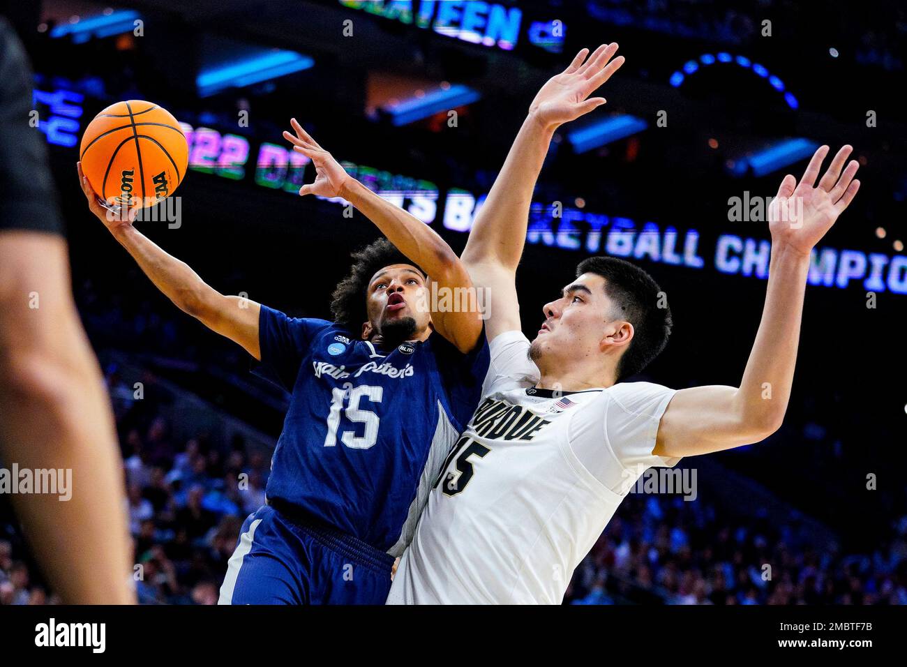 Saint Peter's Matthew Lee, left, goes up for the shot against Purdue 's  Zach Edey, right, during the second half of a college basketball game in  the Sweet 16 round of the